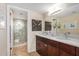 Bright bathroom featuring a double vanity with marble countertop and a decorative-tiled glass shower at 7800 E Lincoln Dr # 1035, Scottsdale, AZ 85250