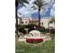 Cabrillo Square entrance with lush landscaping, palm trees, and red flowers offering curb appeal at 7800 E Lincoln Dr # 1035, Scottsdale, AZ 85250
