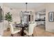 Neutral dining area with modern lighting, decor, and open layout to the kitchen at 7800 E Lincoln Dr # 1035, Scottsdale, AZ 85250