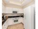 Bright kitchen featuring white cabinets, black countertops, and stainless steel appliances at 7800 E Lincoln Dr # 1035, Scottsdale, AZ 85250