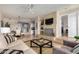 Open-concept living room featuring tile fireplace and views into kitchen and dining at 7800 E Lincoln Dr # 1035, Scottsdale, AZ 85250