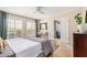 Comfortable main bedroom featuring neutral tones, shutters, and door to living room at 7800 E Lincoln Dr # 1035, Scottsdale, AZ 85250