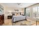 Comfortable main bedroom with ceiling fan, plantation shutters, area rug, and furniture at 7800 E Lincoln Dr # 1035, Scottsdale, AZ 85250