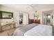 Comfortable main bedroom featuring neutral tones, ceiling fan, and door to bathroom at 7800 E Lincoln Dr # 1035, Scottsdale, AZ 85250