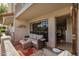 Charming patio area with a comfortable sofa, rug, and a view of the home's architecture at 7800 E Lincoln Dr # 1035, Scottsdale, AZ 85250