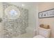 Stylish bathroom with a glass-enclosed shower featuring decorative tile and a unique window at 7800 E Lincoln Dr # 1035, Scottsdale, AZ 85250