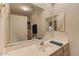 Modern bathroom with white countertops, a large mirror, and contemporary fixtures at 8245 E Bell Rd # 128, Scottsdale, AZ 85260