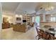 Well-lit dining area featuring a glass table, four chairs, and an open concept to the kitchen at 8245 E Bell Rd # 128, Scottsdale, AZ 85260