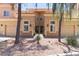 Inviting condo with a stucco exterior, a two-car garage, manicured landscaping, and a terracotta roof at 8245 E Bell Rd # 128, Scottsdale, AZ 85260