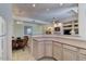 Open-concept kitchen featuring light wood cabinets, a breakfast nook, and modern decor at 8245 E Bell Rd # 128, Scottsdale, AZ 85260