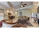 Comfortable living room with a ceiling fan, tile floors, fireplace, and elegant furniture at 8245 E Bell Rd # 128, Scottsdale, AZ 85260