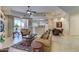 Spacious living room showcasing stylish furniture, tile floors, a ceiling fan, and access to the balcony at 8245 E Bell Rd # 128, Scottsdale, AZ 85260