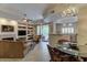 Open floor plan with an adjacent living and dining area, built-in shelves, and access to the patio at 8245 E Bell Rd # 128, Scottsdale, AZ 85260
