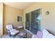 Covered patio with comfortable seating and sliding glass doors to the home's interior at 8245 E Bell Rd # 128, Scottsdale, AZ 85260