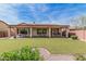 Enjoy the expansive backyard with synthetic grass and a covered patio, perfect for entertaining at 8307 S Desert Preserve Ct, Gold Canyon, AZ 85118