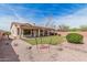 Beautiful backyard features artificial grass, covered patio, and low-maintenance desert landscaping at 8307 S Desert Preserve Ct, Gold Canyon, AZ 85118