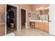 En-suite bathroom featuring tile flooring, wood vanity and walk-in closet at 8307 S Desert Preserve Ct, Gold Canyon, AZ 85118