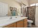 Bathroom featuring tile floors, wood vanity with light countertop and shower-tub combo at 8307 S Desert Preserve Ct, Gold Canyon, AZ 85118
