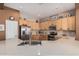 Bright kitchen featuring stainless appliances, wooden cabinetry and a large island with sink at 8307 S Desert Preserve Ct, Gold Canyon, AZ 85118