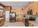 Bright kitchen featuring stainless appliances, wooden cabinetry, tile floors and light countertops at 8307 S Desert Preserve Ct, Gold Canyon, AZ 85118