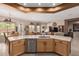 Bright kitchen featuring wooden cabinetry, stainless appliances and a view to the dining and living area at 8307 S Desert Preserve Ct, Gold Canyon, AZ 85118