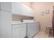 Convenient laundry room with ample storage, modern appliances, and a functional layout at 8307 S Desert Preserve Ct, Gold Canyon, AZ 85118