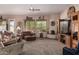 Inviting living room features a ceiling fan and a charming corner fireplace at 8307 S Desert Preserve Ct, Gold Canyon, AZ 85118