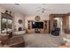 Comfortable living room featuring a ceiling fan and corner fireplace at 8307 S Desert Preserve Ct, Gold Canyon, AZ 85118