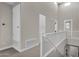 Upstairs hallway featuring carpet, white railing, multiple doors, and vaulted ceilings at 8340 E Mcdonald Dr # 1016, Scottsdale, AZ 85250