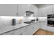 Beautiful kitchen counter featuring modern fixtures, countertops, and herringbone tile backsplash at 8340 E Mcdonald Dr # 1016, Scottsdale, AZ 85250