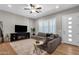 Bright living room featuring a comfortable sectional, hardwood floors, and natural light at 8340 E Mcdonald Dr # 1016, Scottsdale, AZ 85250