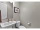 This powder room features a pedestal sink, toilet, neutral paint, and decor at 8340 E Mcdonald Dr # 1016, Scottsdale, AZ 85250