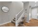 Staircase with light-colored carpet and white risers, wood floors, bar cart, and decor at 8340 E Mcdonald Dr # 1016, Scottsdale, AZ 85250