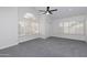 Bright, spacious bedroom with neutral walls, ceiling fan, and lots of natural light at 9035 E Lupine Ave, Scottsdale, AZ 85260
