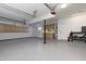 Spacious garage featuring epoxy flooring, cabinets, and ample storage, providing functionality and organization at 9035 E Lupine Ave, Scottsdale, AZ 85260