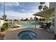 Backyard oasis boasting a sparkling pool, hot tub, slide, and covered patio for relaxation and enjoyment at 9035 E Lupine Ave, Scottsdale, AZ 85260