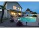 Nighttime view showcasing a well-lit pool, covered patio, and landscaped backyard, great for evening enjoyment at 9035 E Lupine Ave, Scottsdale, AZ 85260