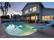 Backyard view featuring a refreshing pool with a slide, complemented by a covered patio area at 9035 E Lupine Ave, Scottsdale, AZ 85260