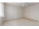 Carpeted bedroom with a ceiling fan, light walls, and natural light at 10619 W Highwood Ln, Sun City, AZ 85373