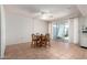 Dining area with an open view to the kitchen with white cabinetry at 10619 W Highwood Ln, Sun City, AZ 85373