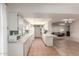 Galley kitchen with white cabinets and an open layout into a dining area at 10619 W Highwood Ln, Sun City, AZ 85373