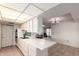 The kitchen features white cabinets, a breakfast bar, and tile floors, open to the living space at 10619 W Highwood Ln, Sun City, AZ 85373