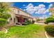Expansive backyard featuring a lush lawn, mature trees, colorful flowers, and a covered patio at 1074 E Carla Vista Ct, Gilbert, AZ 85295