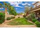 Landscaped backyard boasts a well-manicured lawn bordered by gravel and flowering bushes at 1074 E Carla Vista Ct, Gilbert, AZ 85295