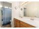 Bathroom with a double sink vanity, large mirror and a shower/tub combo with blue shower curtain at 1074 E Carla Vista Ct, Gilbert, AZ 85295