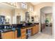 Well-lit bathroom with granite countertops, dual sinks, and ample storage at 1074 E Carla Vista Ct, Gilbert, AZ 85295