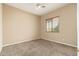 Neutral bedroom featuring a ceiling fan, carpet, and a window bringing in natural light at 1074 E Carla Vista Ct, Gilbert, AZ 85295
