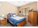Cozy bedroom featuring wood furniture, ceiling fan, and plush carpet for ultimate relaxation at 1074 E Carla Vista Ct, Gilbert, AZ 85295