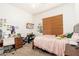 Bright bedroom with desk, TV, and cozy decor for a comfortable living space at 1074 E Carla Vista Ct, Gilbert, AZ 85295