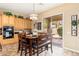 Dining area adjacent to the kitchen with a wooden table, chairs, and a sliding glass door to the patio at 1074 E Carla Vista Ct, Gilbert, AZ 85295